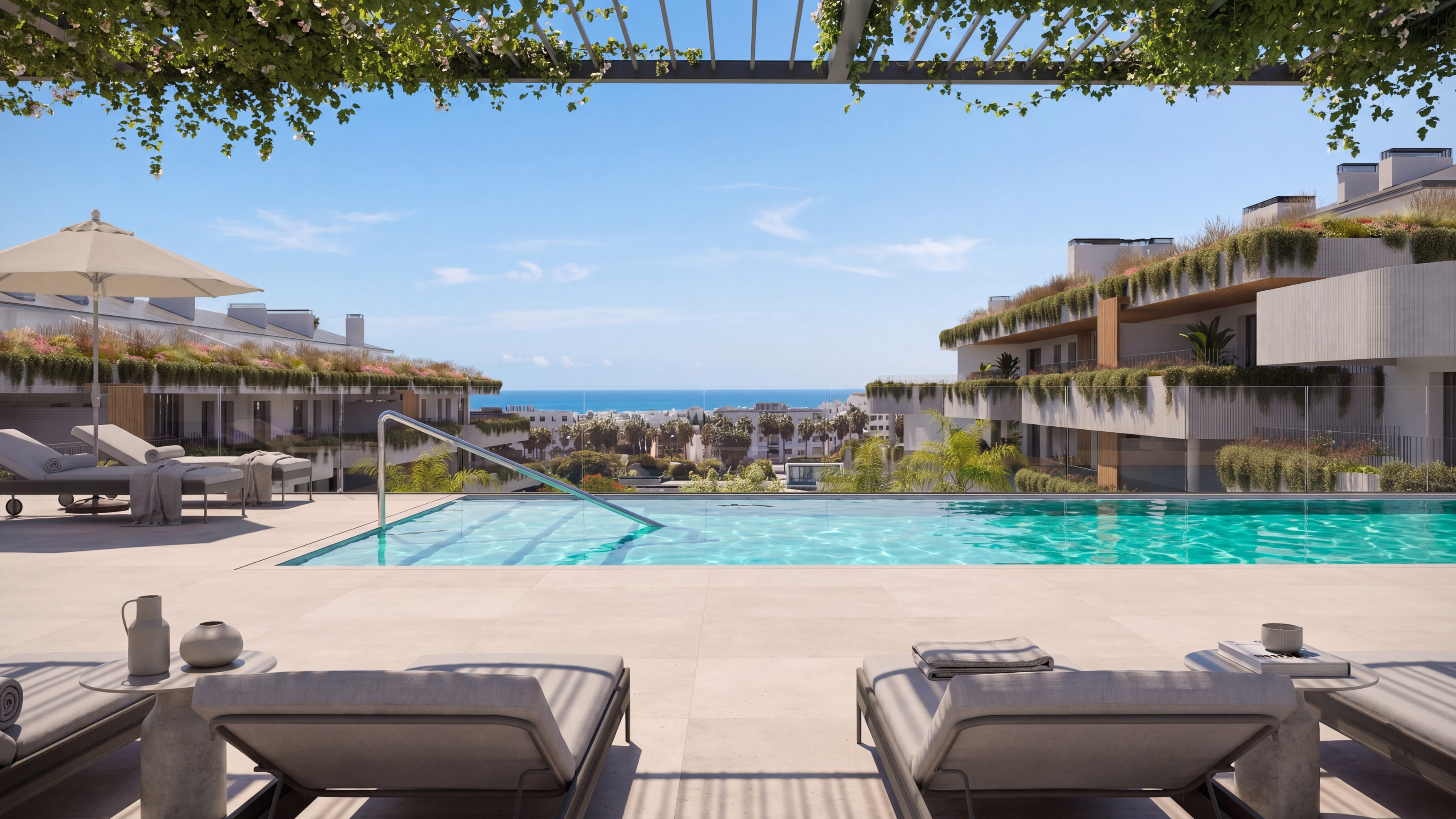 Resort pool with sunbeds and sea views